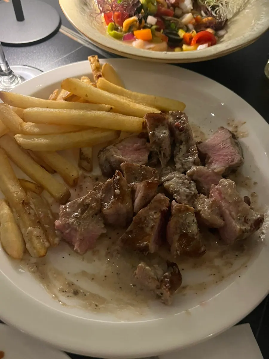 Pork steak sliced smoothly, served with fries