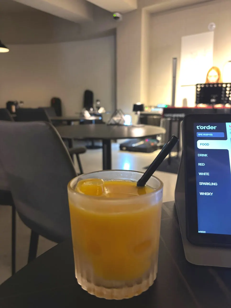 Orange juice with a straw served at Allegro