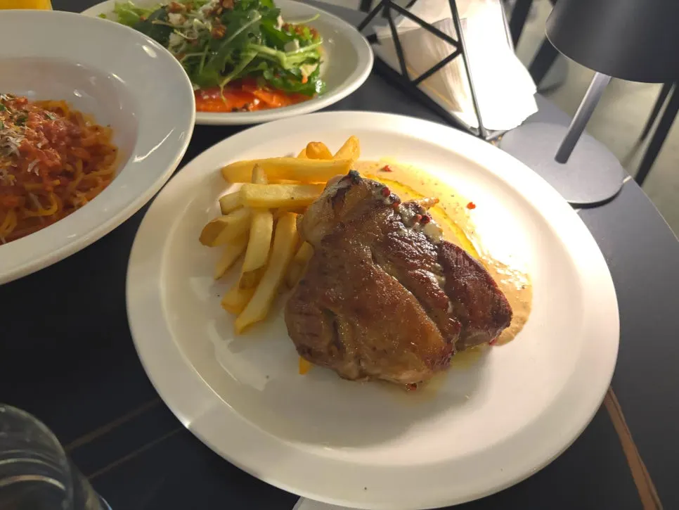 Cross-section of the sous-vide pork shoulder steak with potatoes and sauce