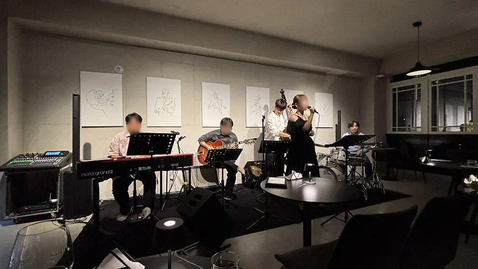 Four-piece jazz stage with piano, guitar, bass, and drums