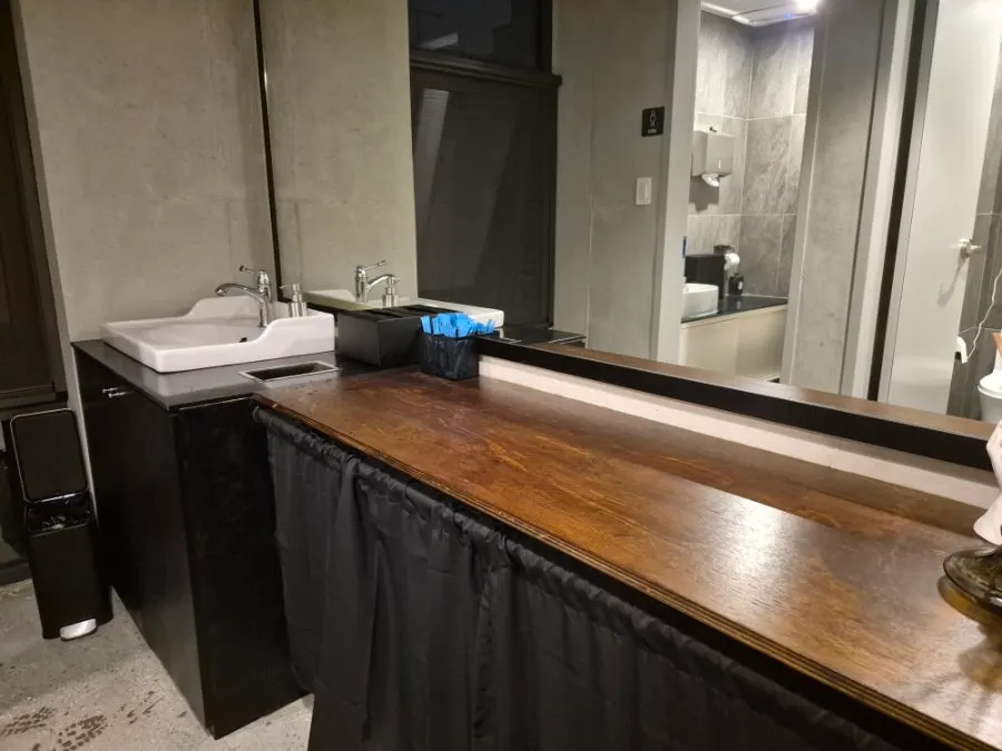 Entrance to the separate men's and women's restrooms opposite the stage