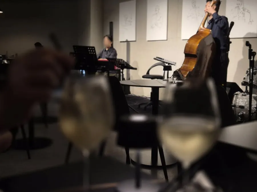 The jazz trio starting to play as wine is poured