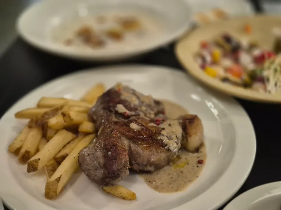 Sous-vide pork shoulder steak served with fries