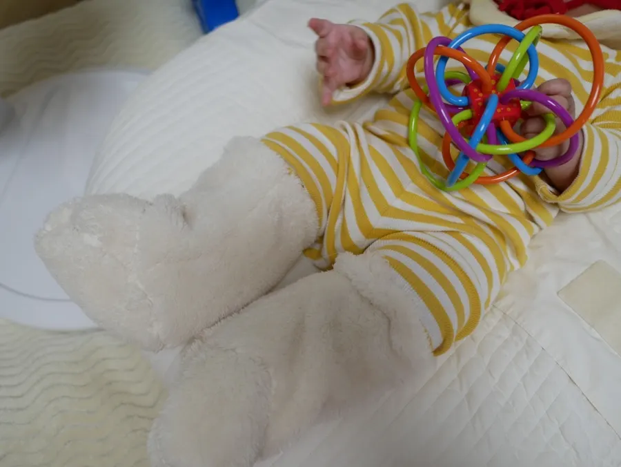 White baby foot warmers that match outfits