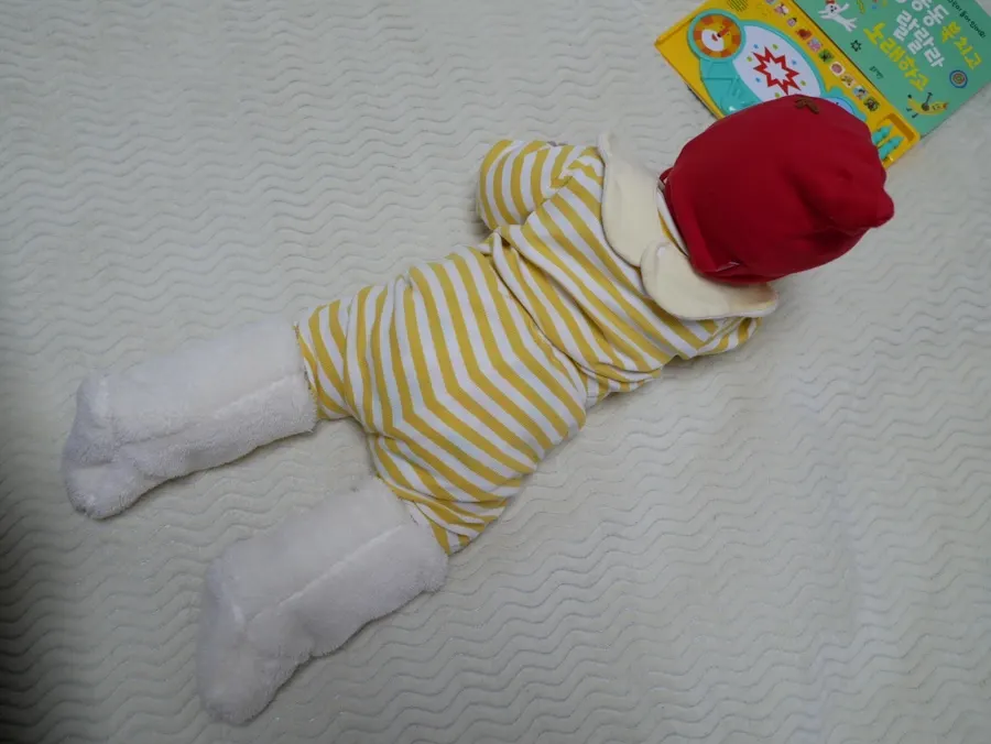 An active baby wearing foot warmers that do not slip down