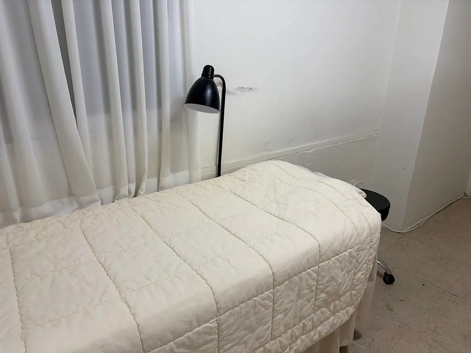 Treatment space in white tones with soft lighting