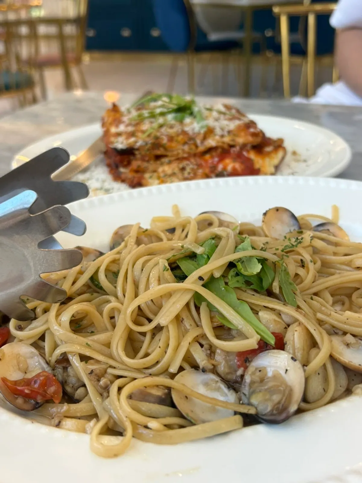 Clam pasta topped with plump clams and arugula