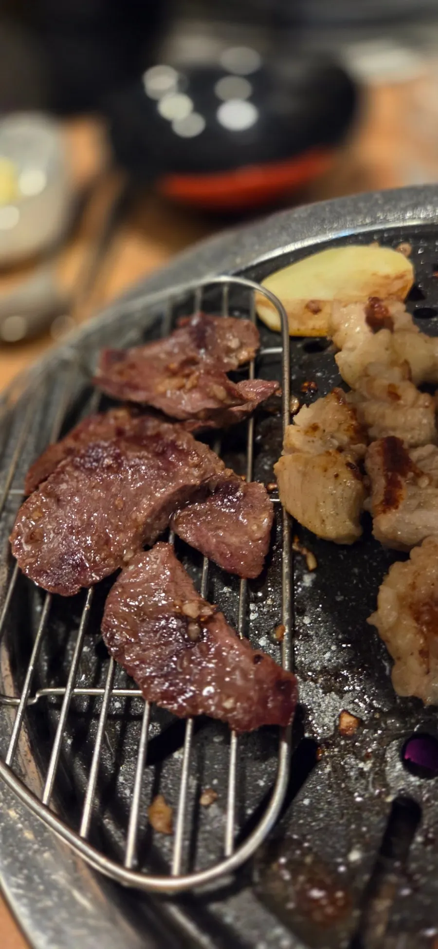 Grill with mixed offal platter being cooked by staff