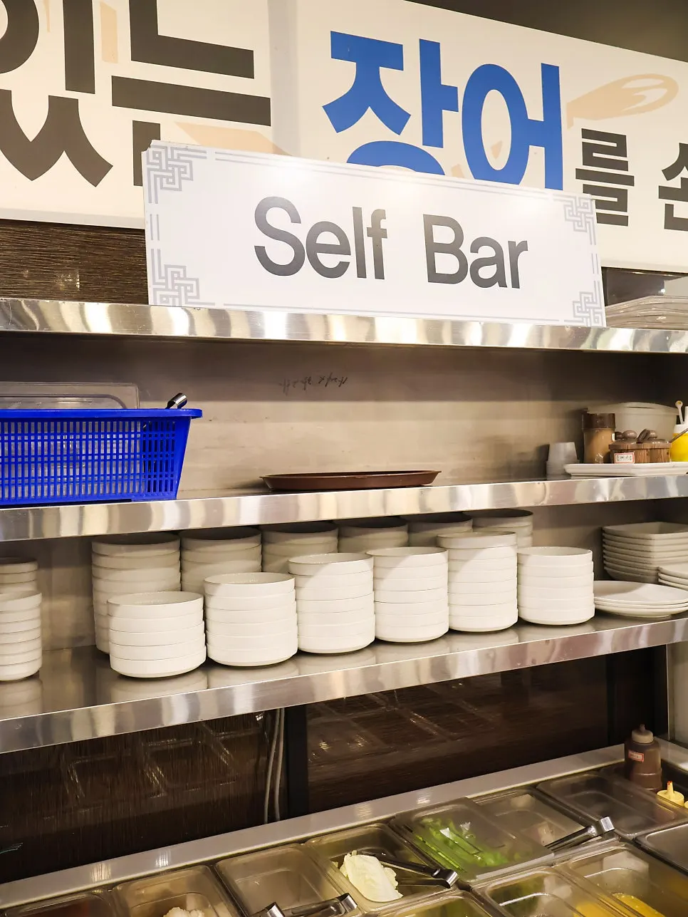 Self-serve vegetable bar with lettuce, perilla leaves, and white kimchi