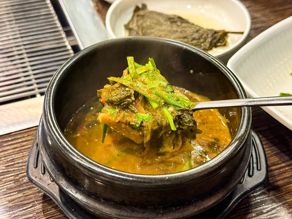 A spoonful of the thick eel soup broth