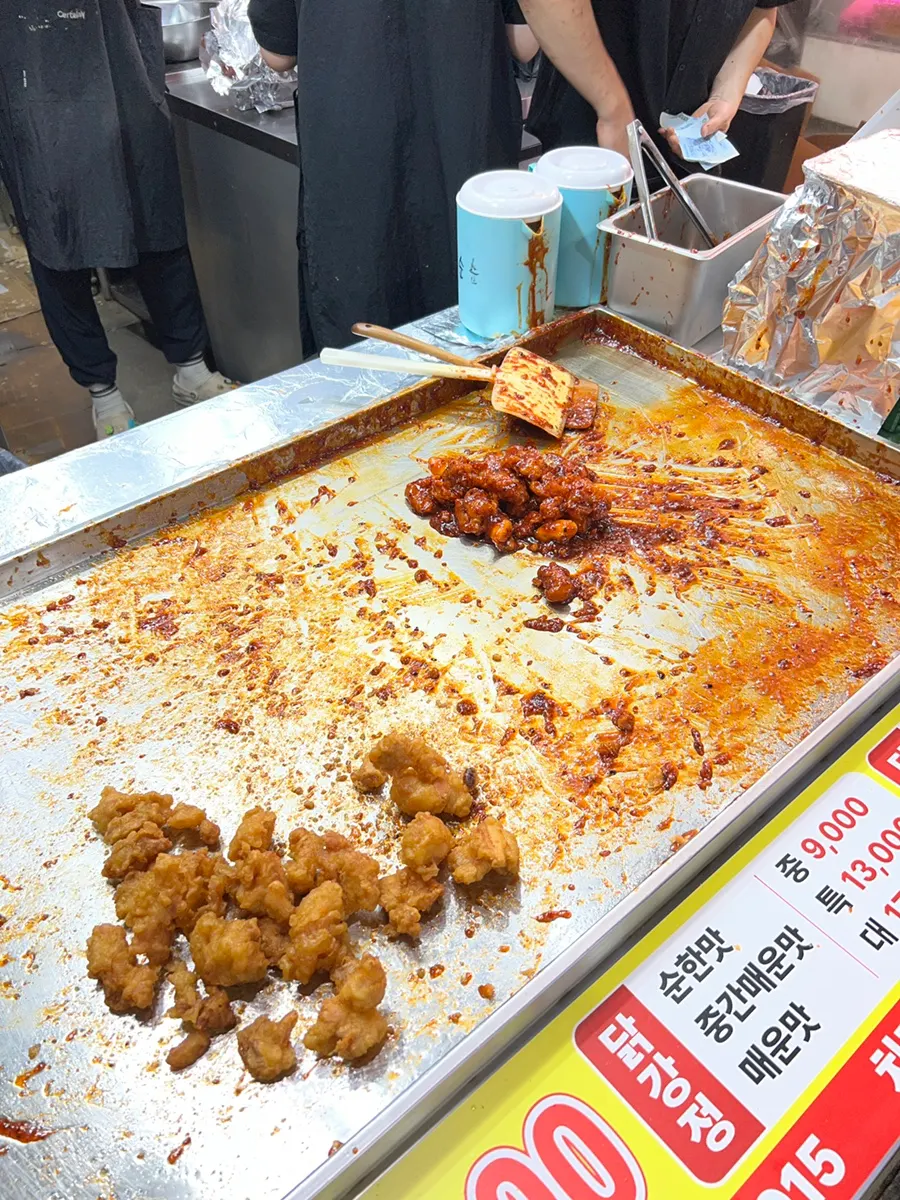 Fried dakgangjeong pieces stacked on display