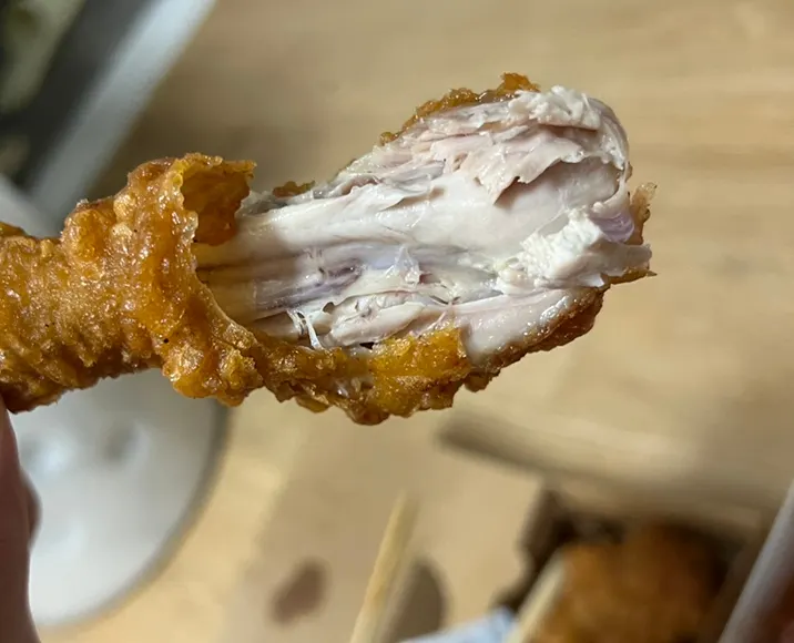 Drumstick showing its crispy batter