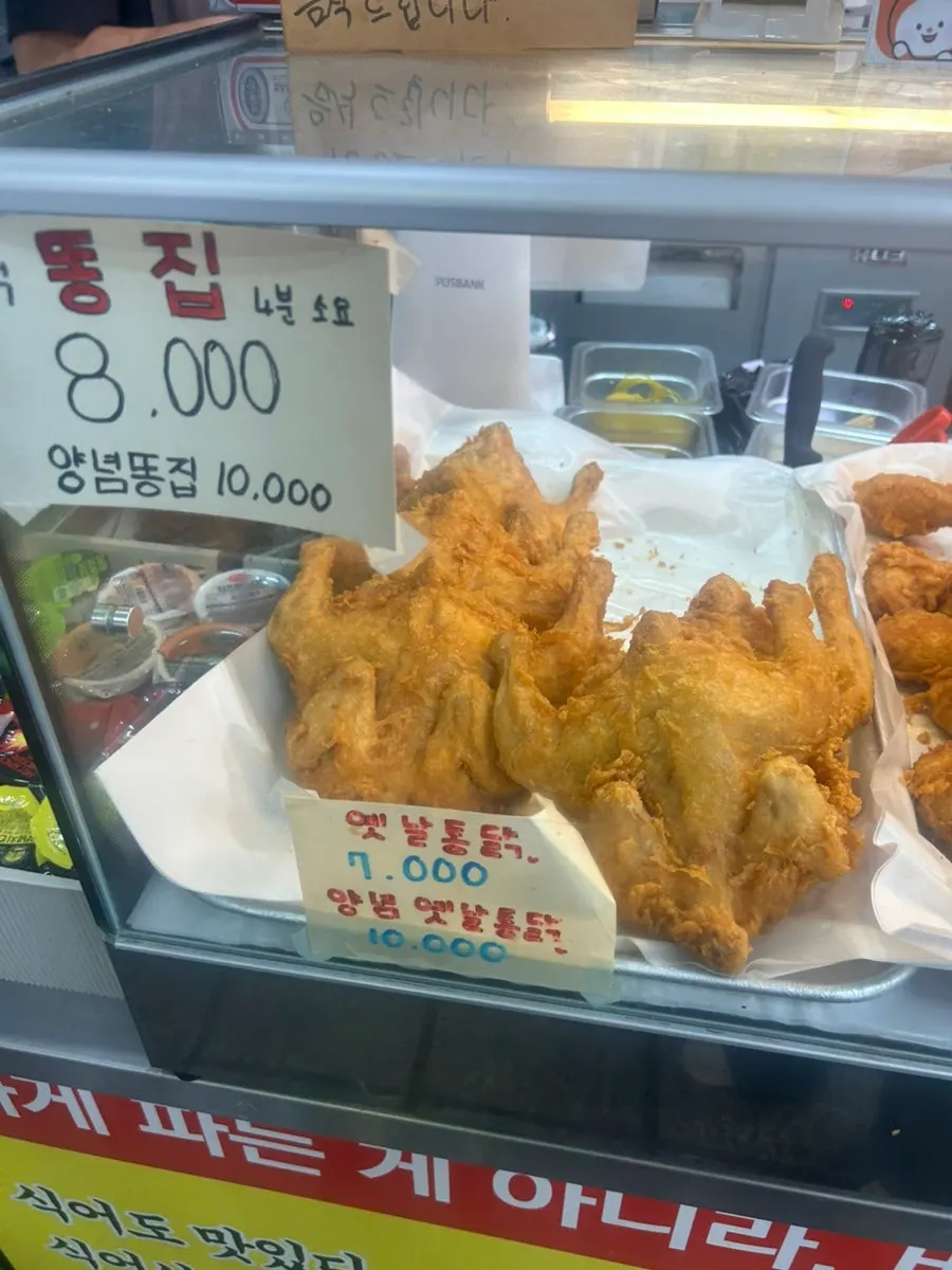 Sign listing old-school fried chicken and other cuts