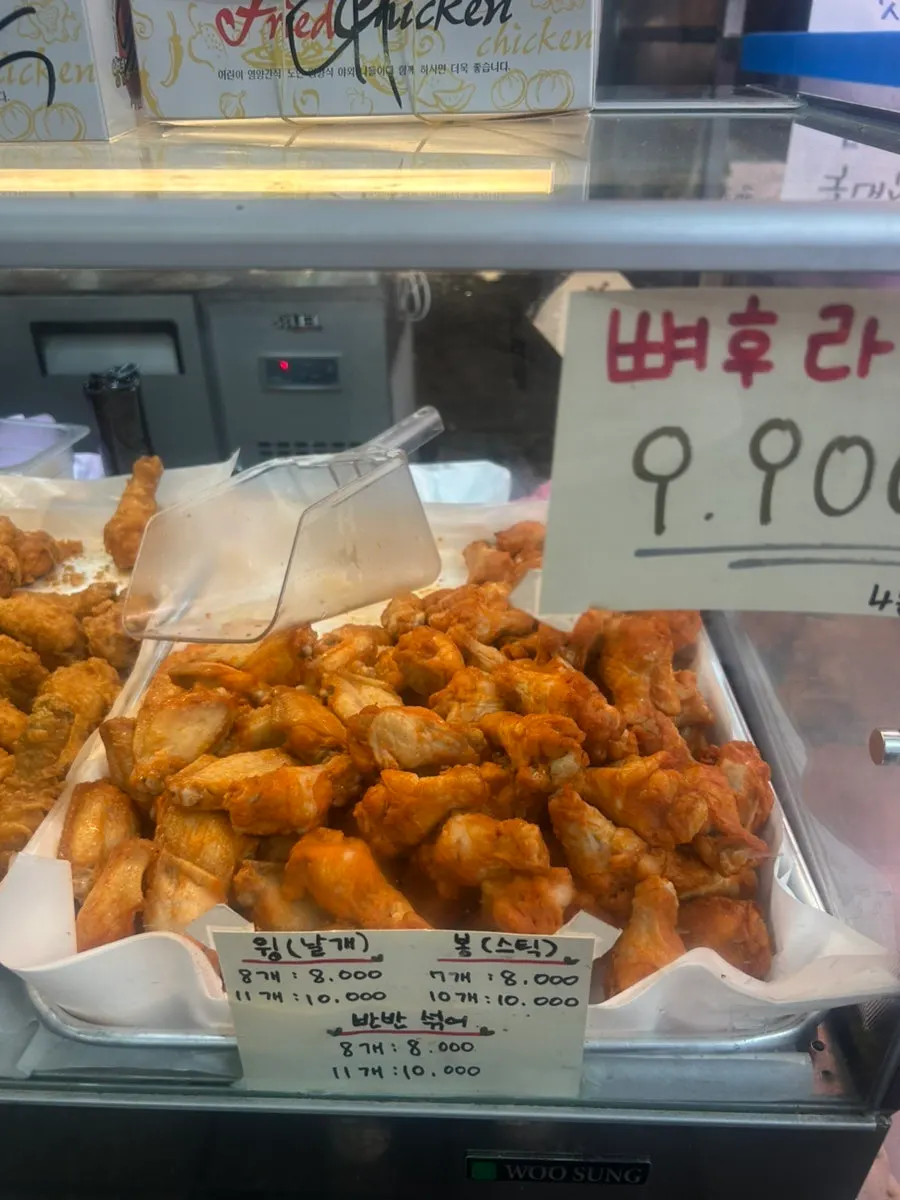 Sign listing bone-in fried chicken, wings, and drumettes