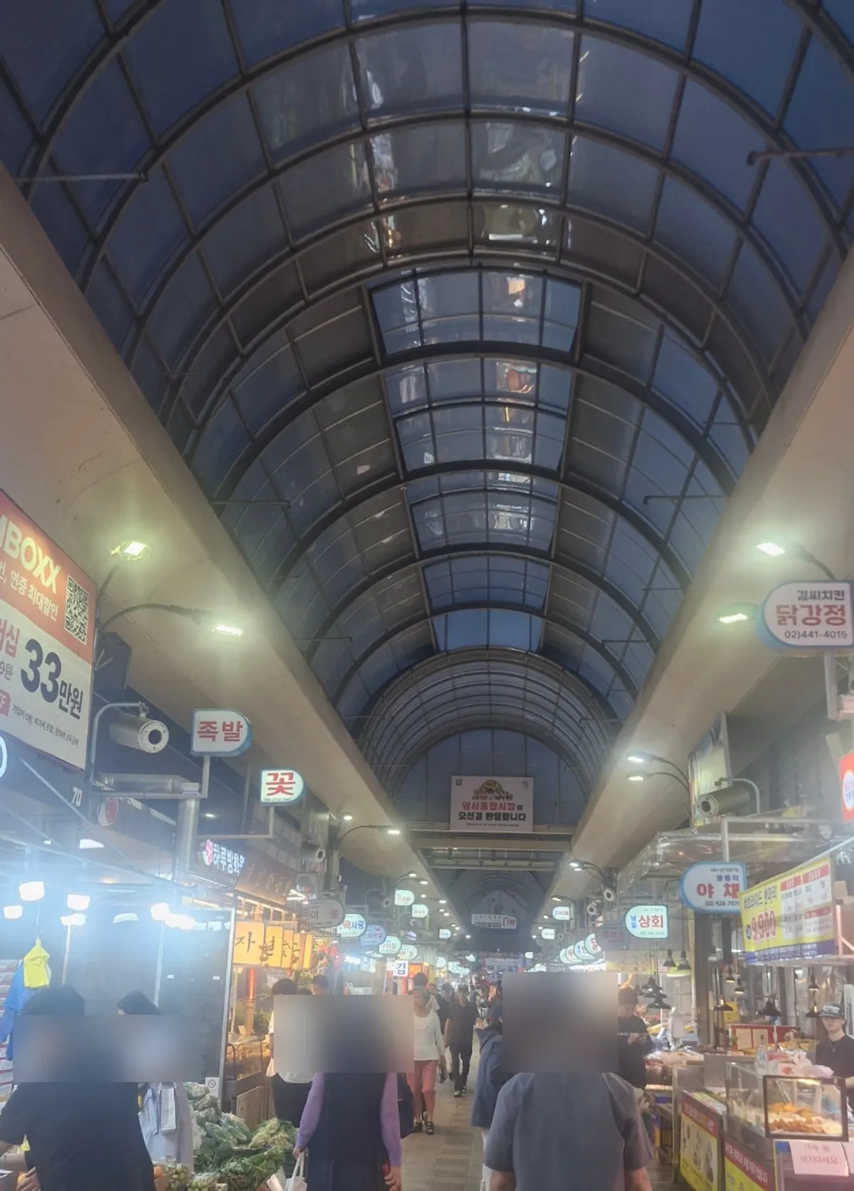 View of Amsa Market with people passing through on a weekday evening