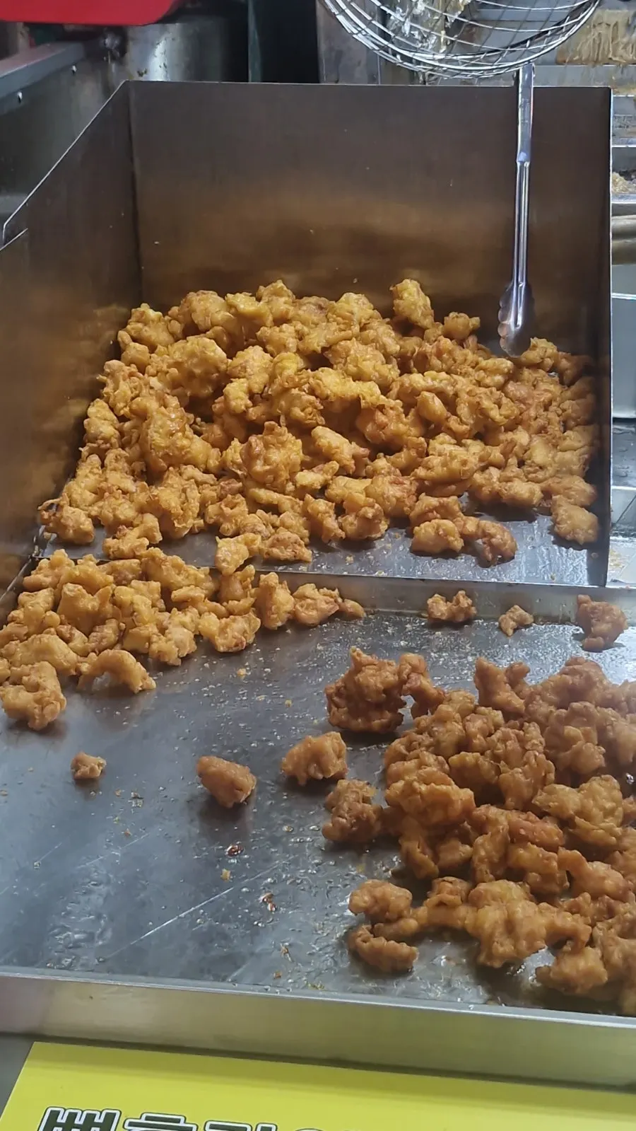 Chicken frying in the fryer
