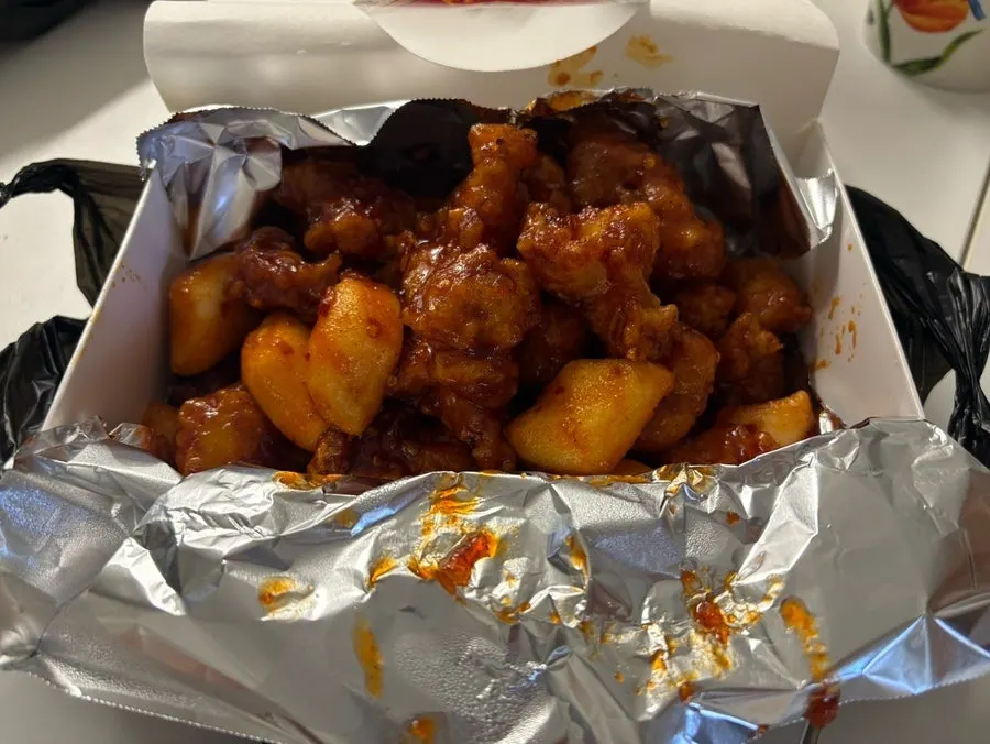 Medium-spicy dakgangjeong with the lid opened