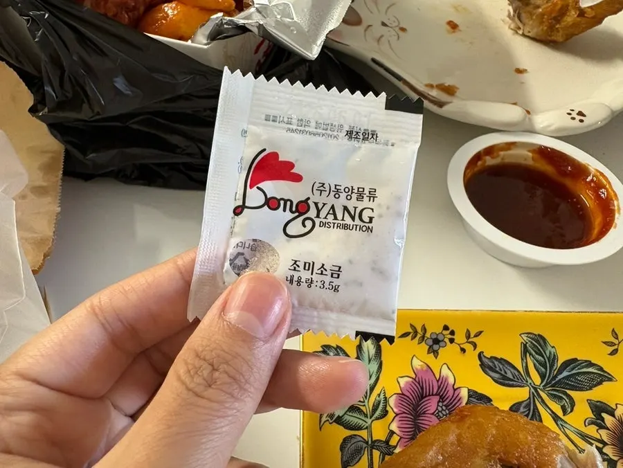 A piece of dakgangjeong picked up with a wooden skewer