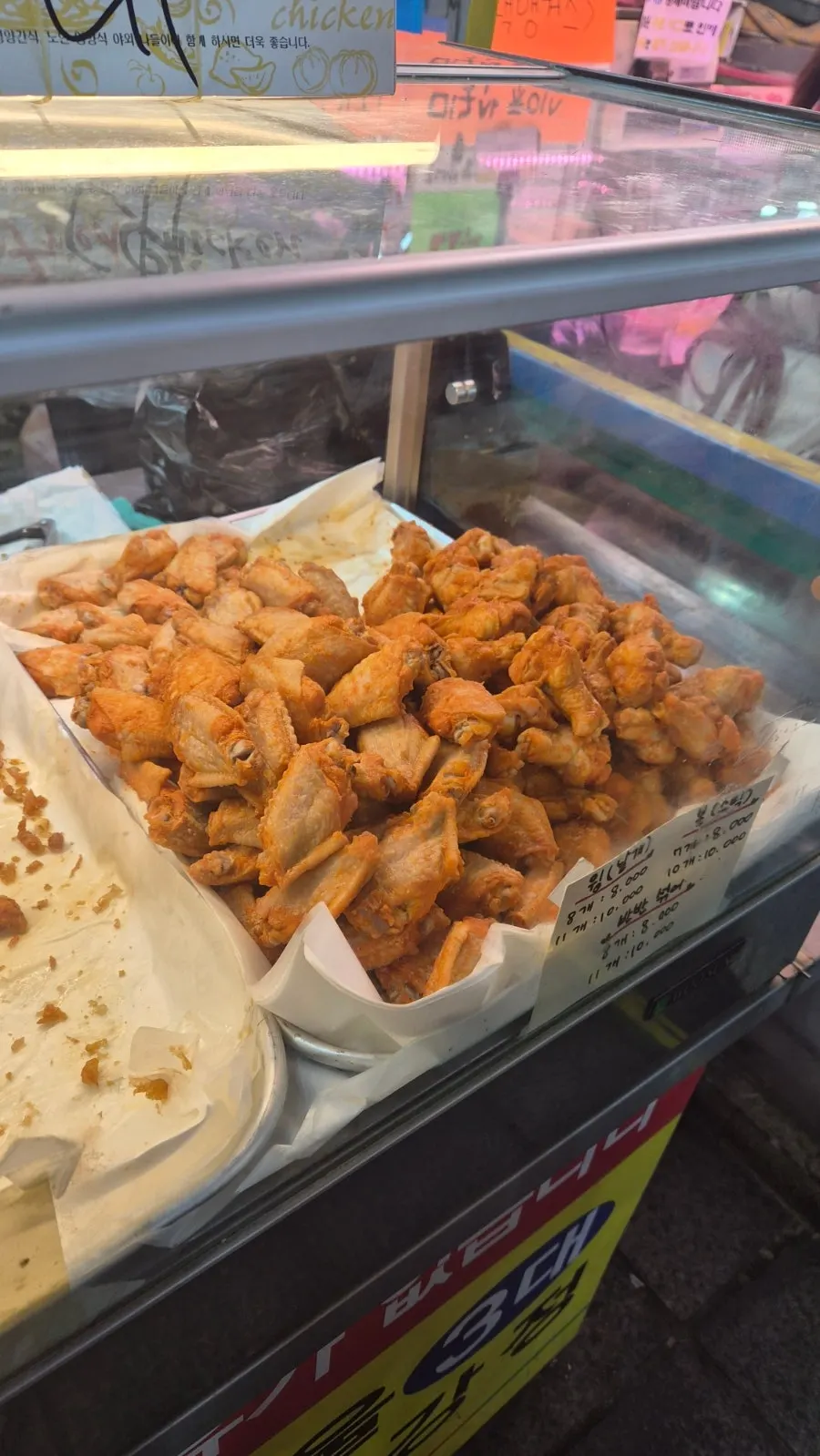 Prep counter piled high with chicken out front