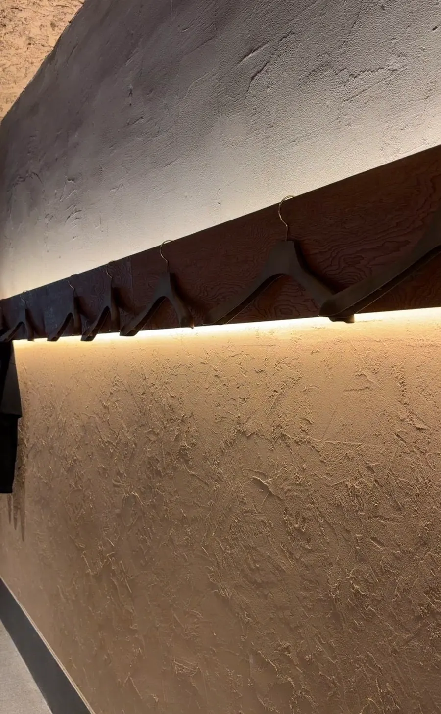 Coat hangers behind the counter seats