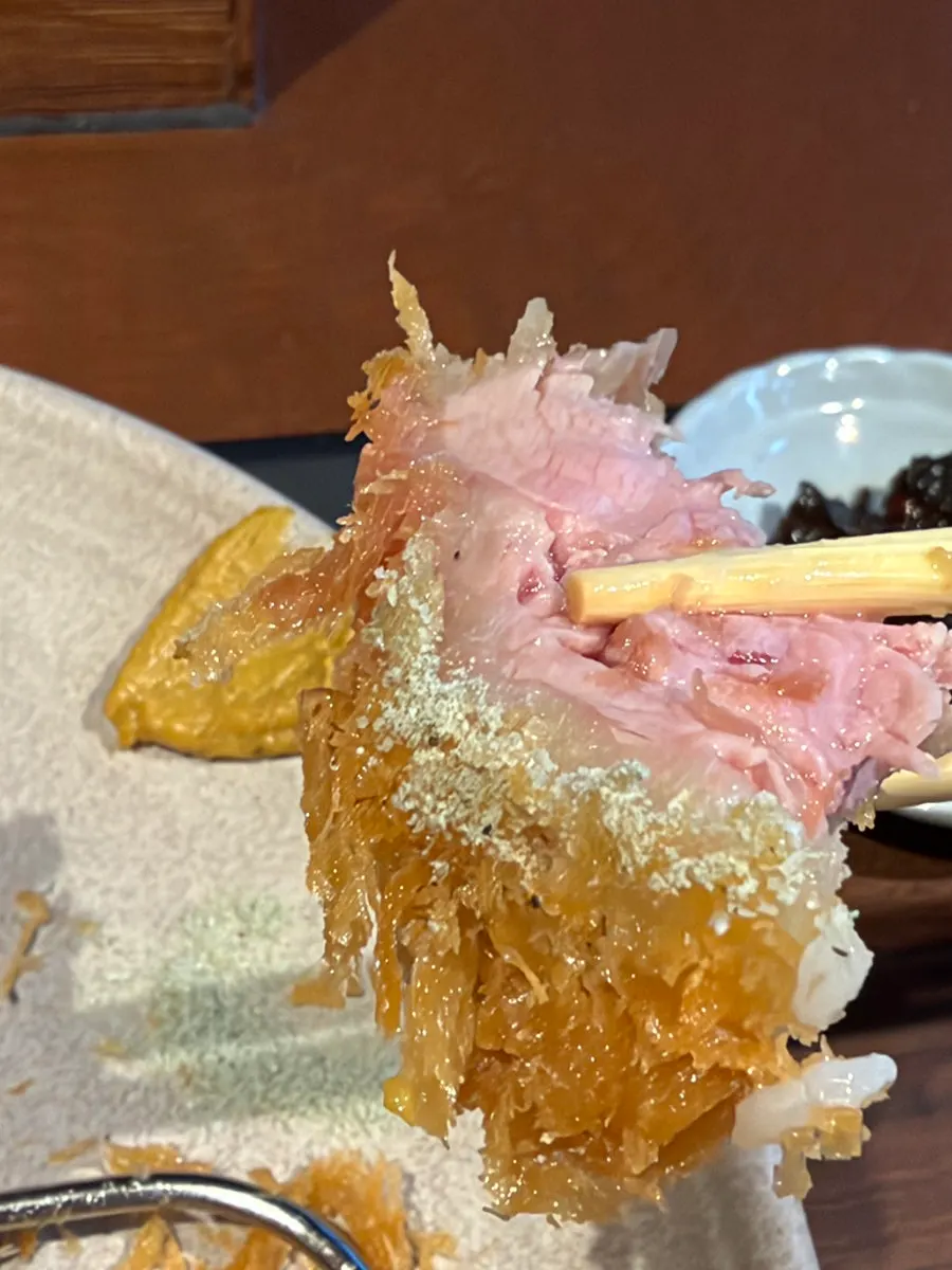 Two pieces of tenderloin katsu with pink cut surfaces