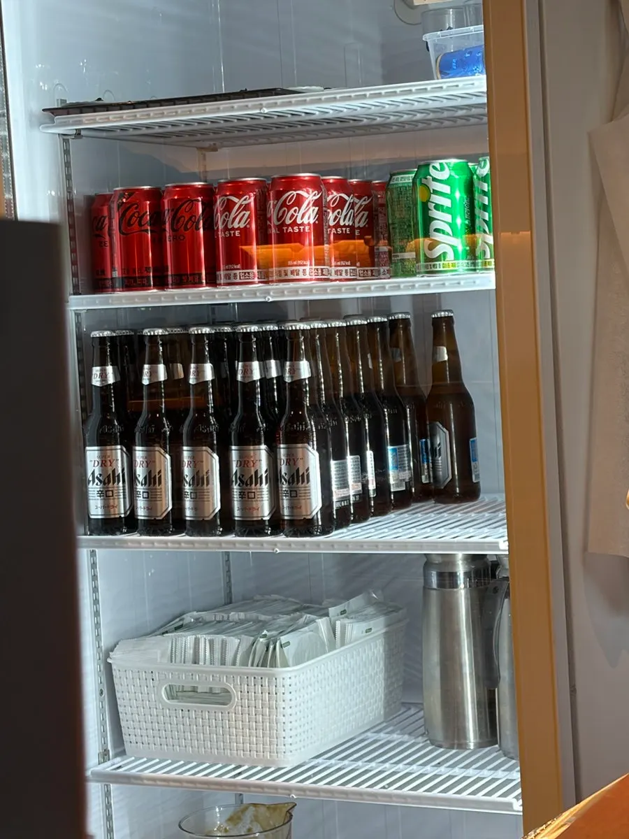Drinks and bottled beer in the fridge next to the counter
