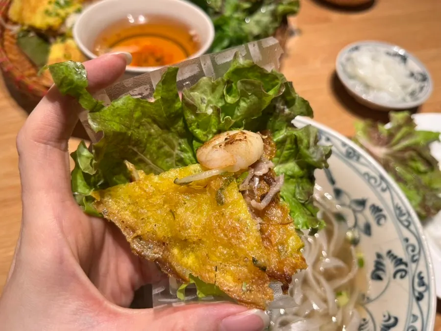 Side vegetables including mint served with banh xeo