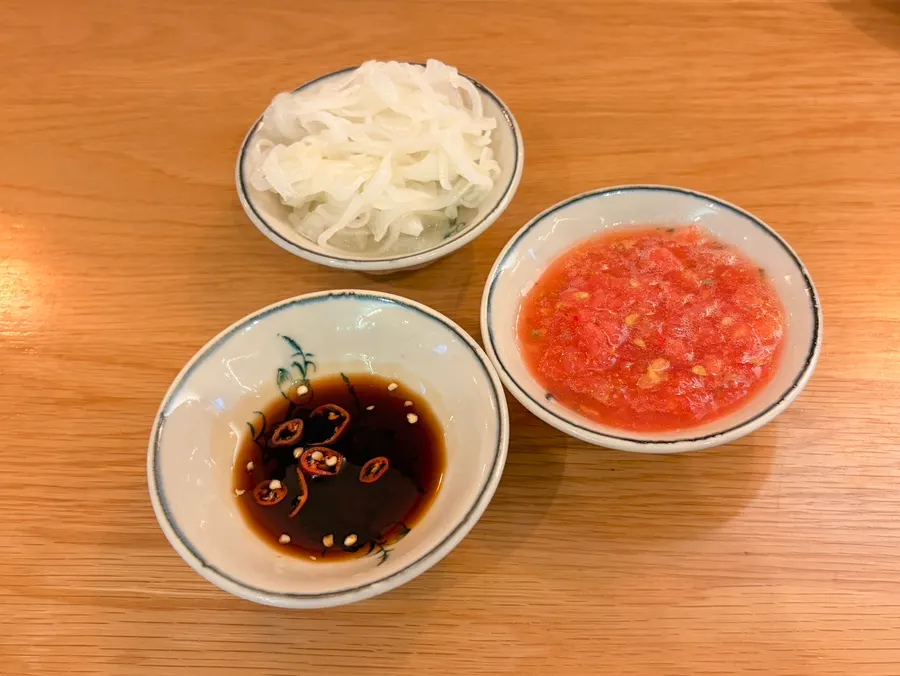 Soy sauce, pickled onion, and tomato sauce served with the fried rice