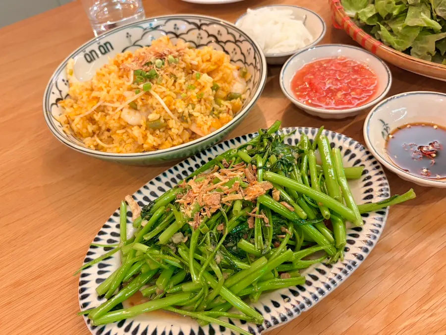 A lunch spread of bun cha, fried rice, and water spinach together