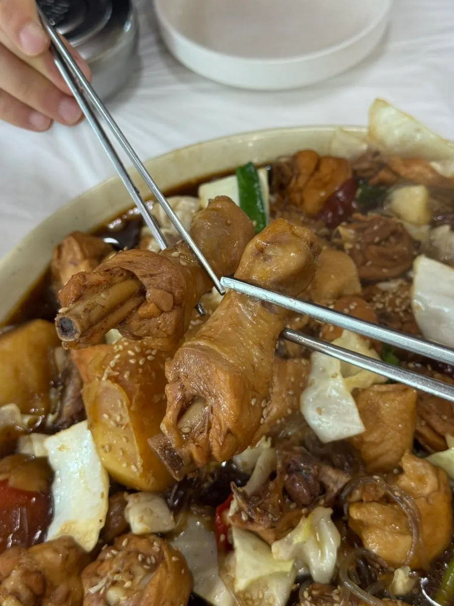 Close-up of jjimdak chicken coated in sauce