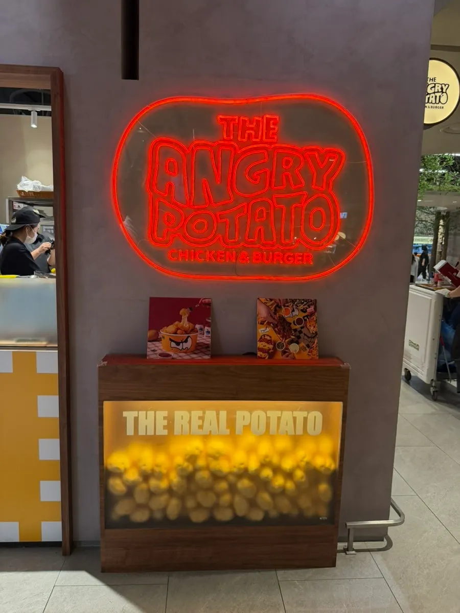 Angry Potato entrance visible right at the bottom of the escalator