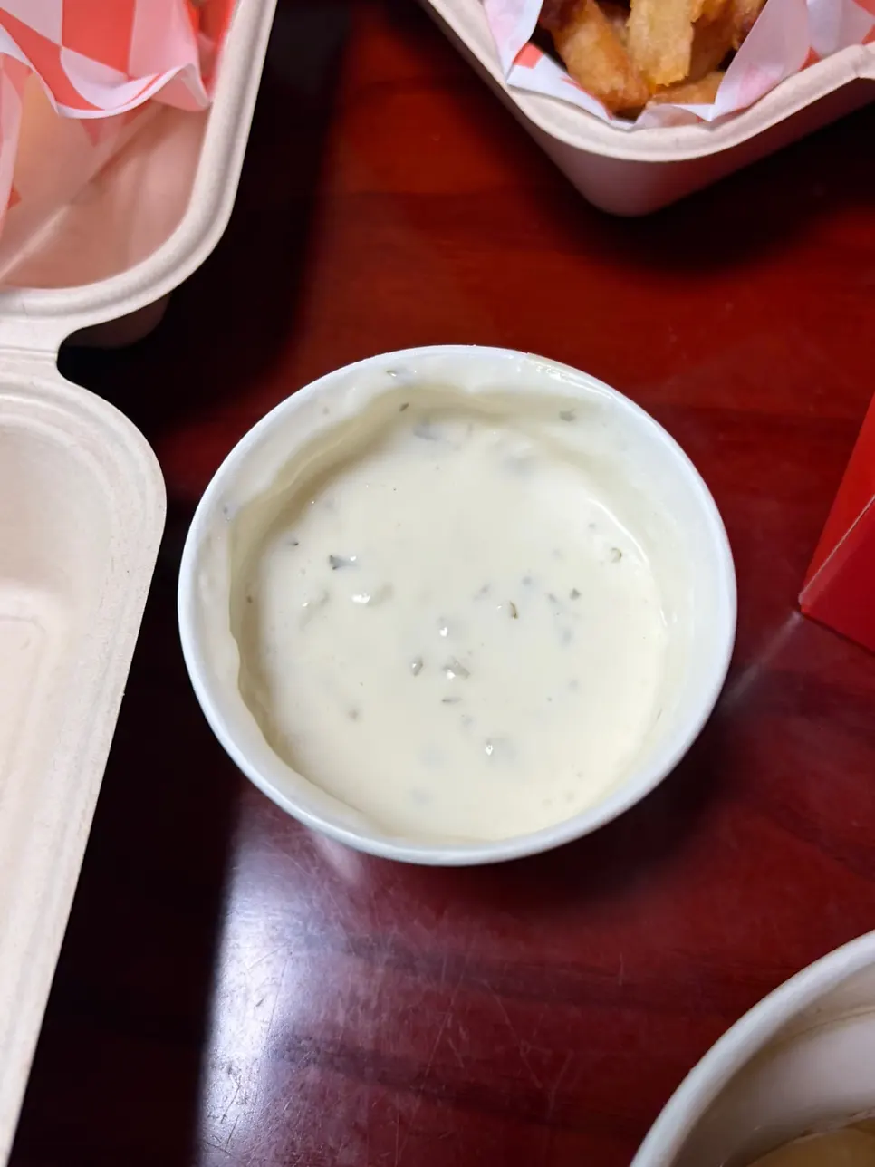 Fries plated in the takeout container