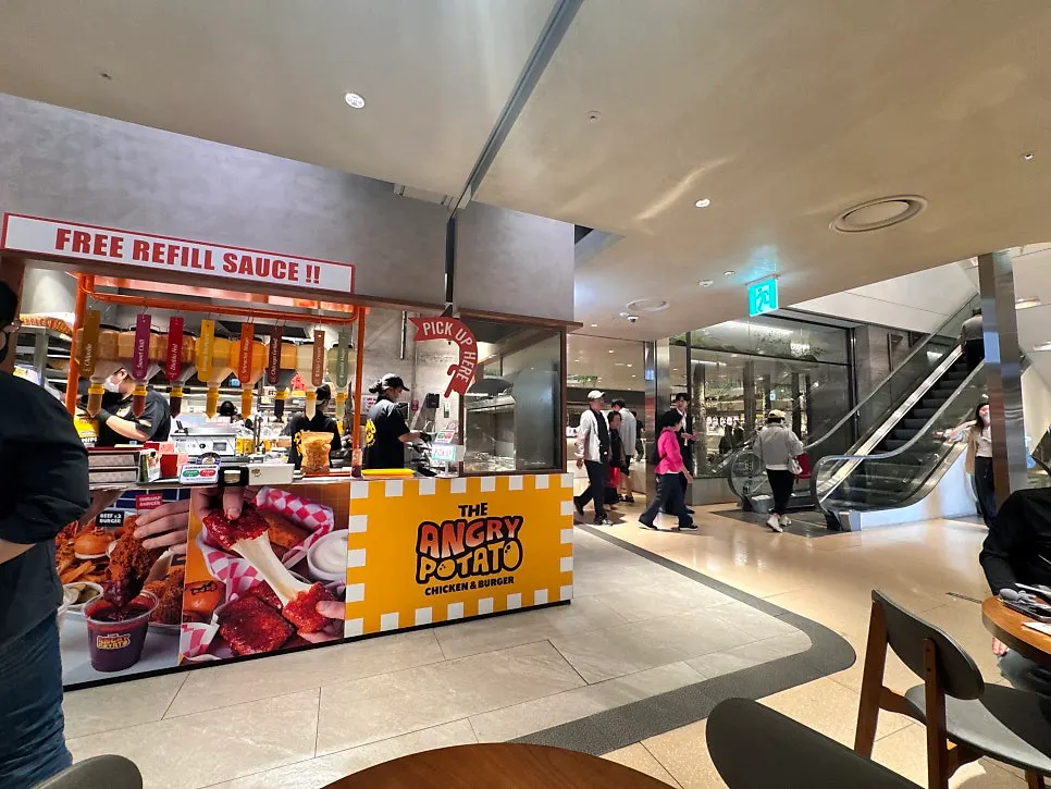 Angry Potato store location visible right from the escalator
