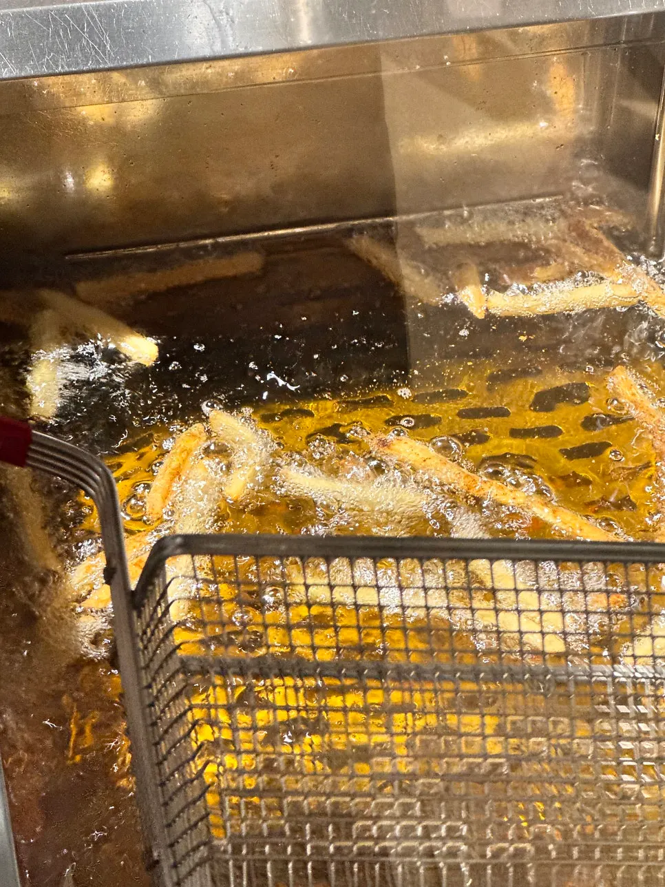 Potatoes and chicken being fried