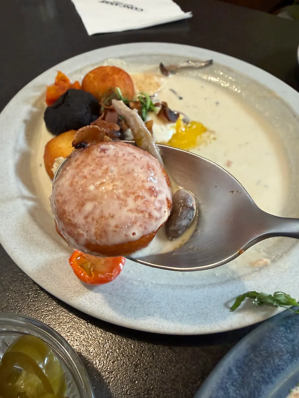 A bite of gnocchi dipped in sauce