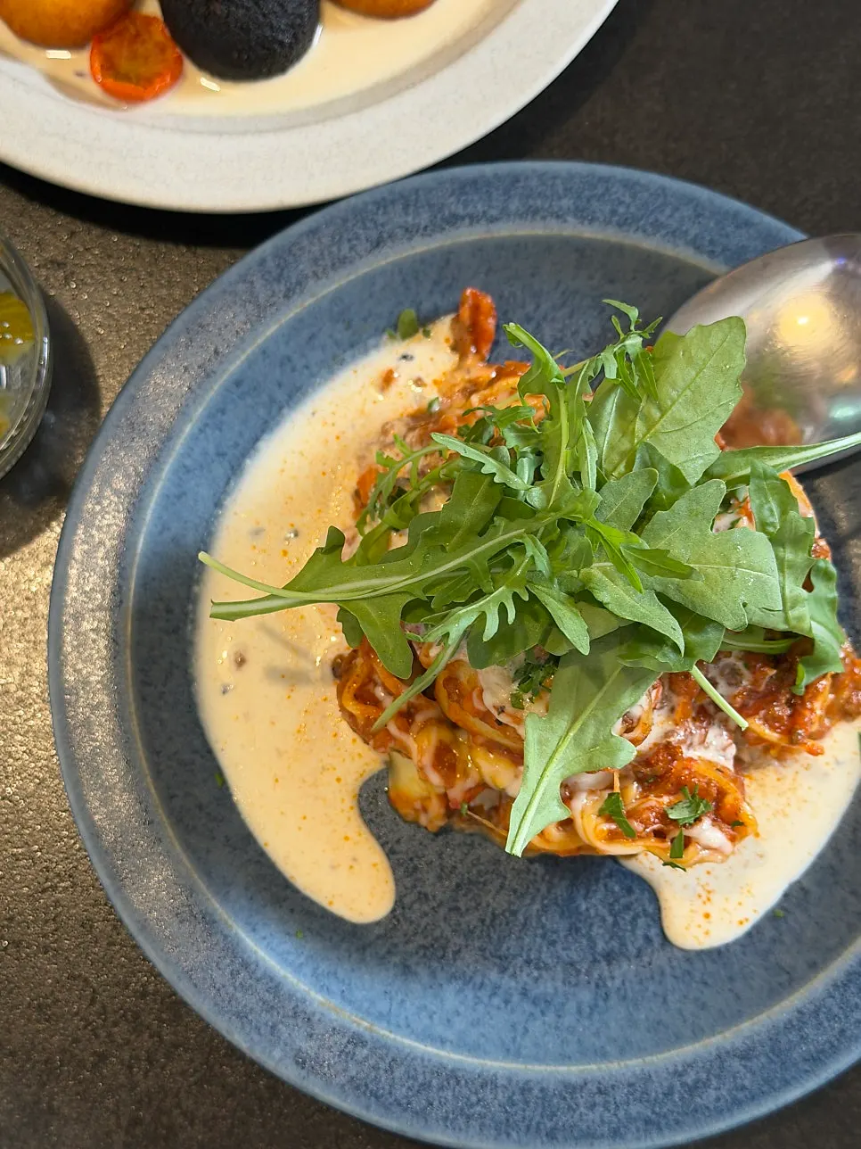 Table setting with Concasse Anguk's signature lasagna