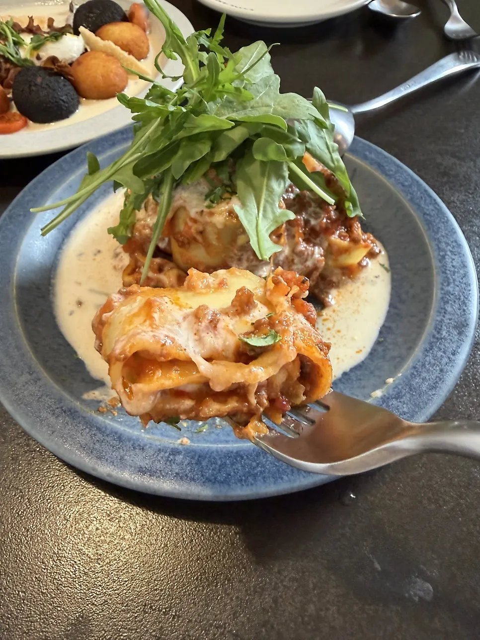 A portion of lasagna scooped out onto a plate