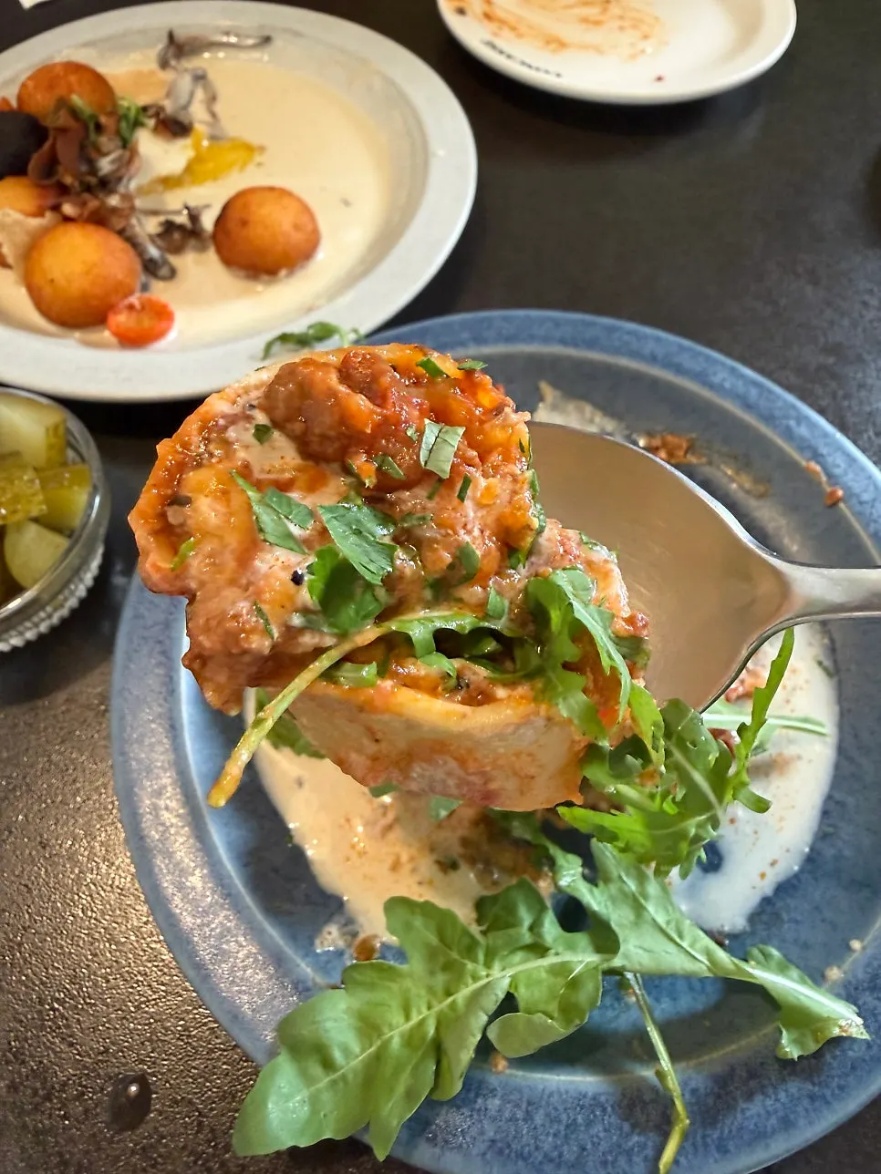 Cross-section of lasagna showing ragu sauce and cheese