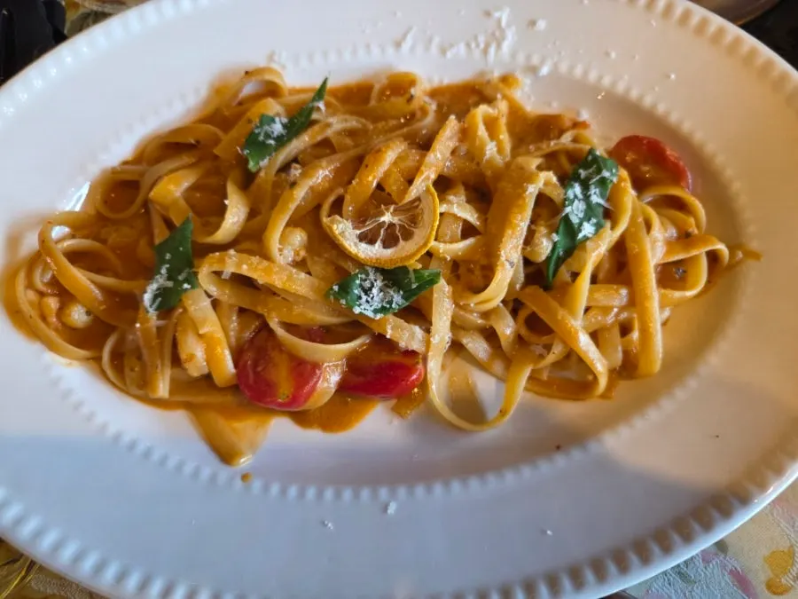 Snow crab guts cream pasta topped with flying fish roe and arugula