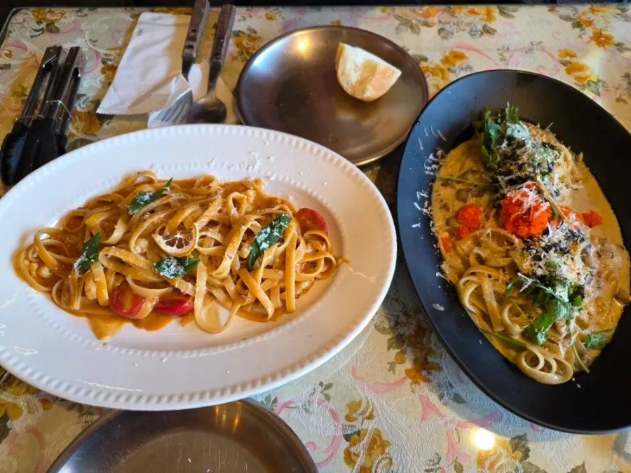 Spicy shrimp bisque pasta in a white oval bowl