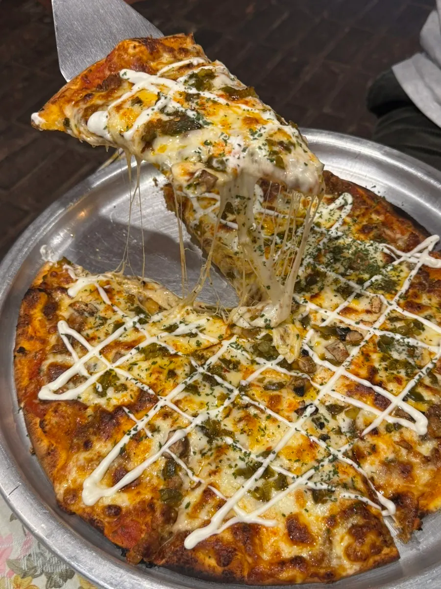 Lasagna pizza topped with meat sauce