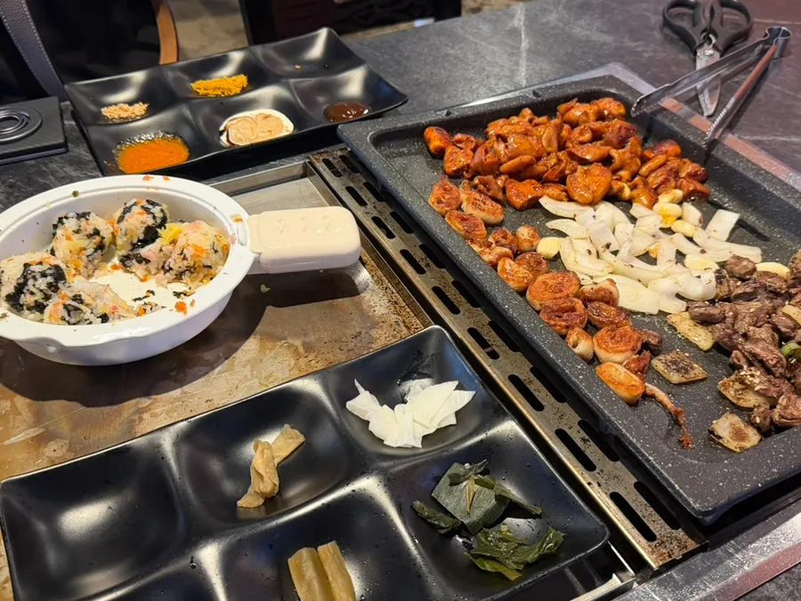 A piece of makchang served on top of pickled side dishes