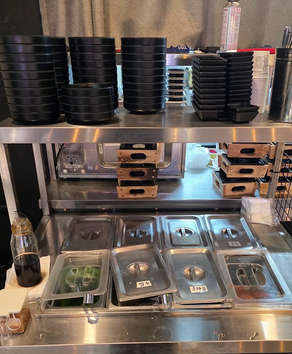 Self-serve bar with perilla leaves, pickled radish, and sauces