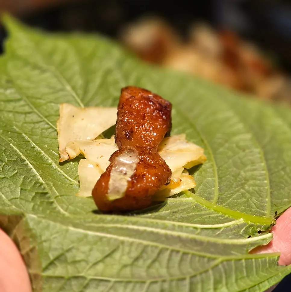 Salt-grilled makchang wrapped in a perilla leaf