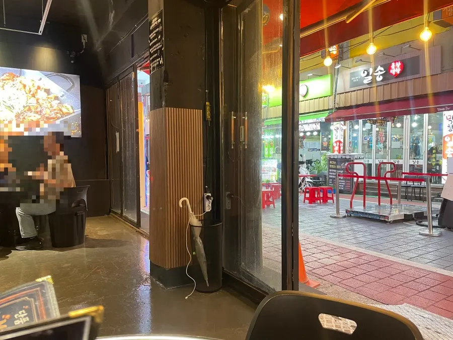 Interior of Gopchang119 with the door open for an outdoor-dining feel