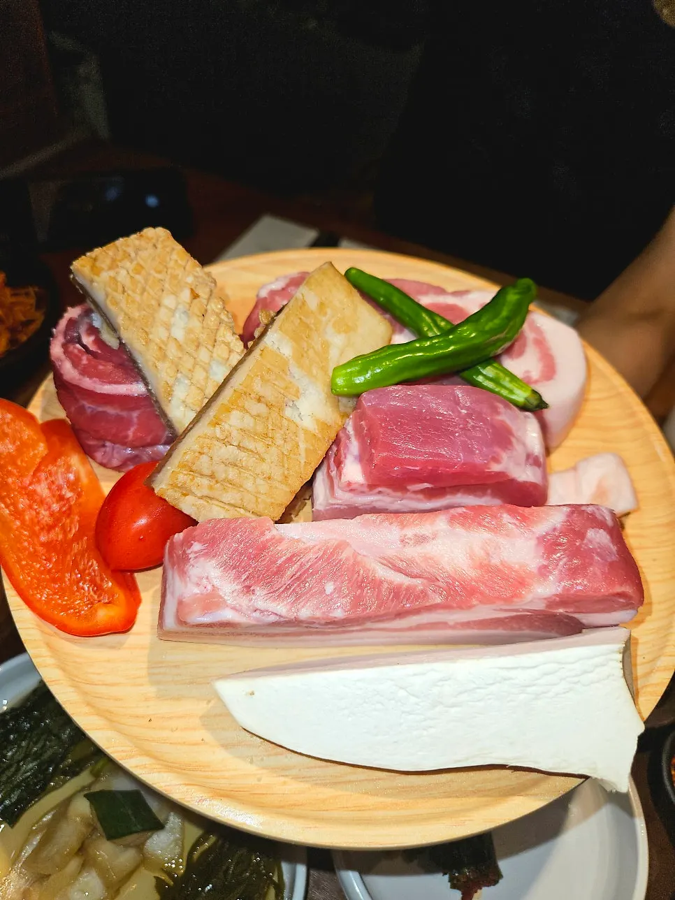 도톰한 삼겹살과 여러 부위가 담긴 고기 한 접시