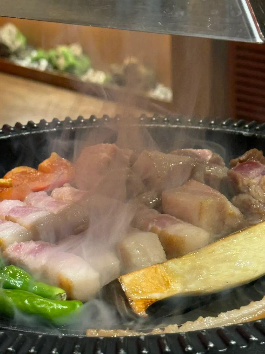 Staff grilling meat tableside