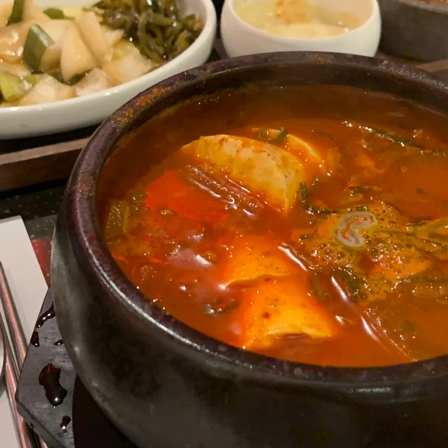 Large pieces of pork inside the soft tofu stew