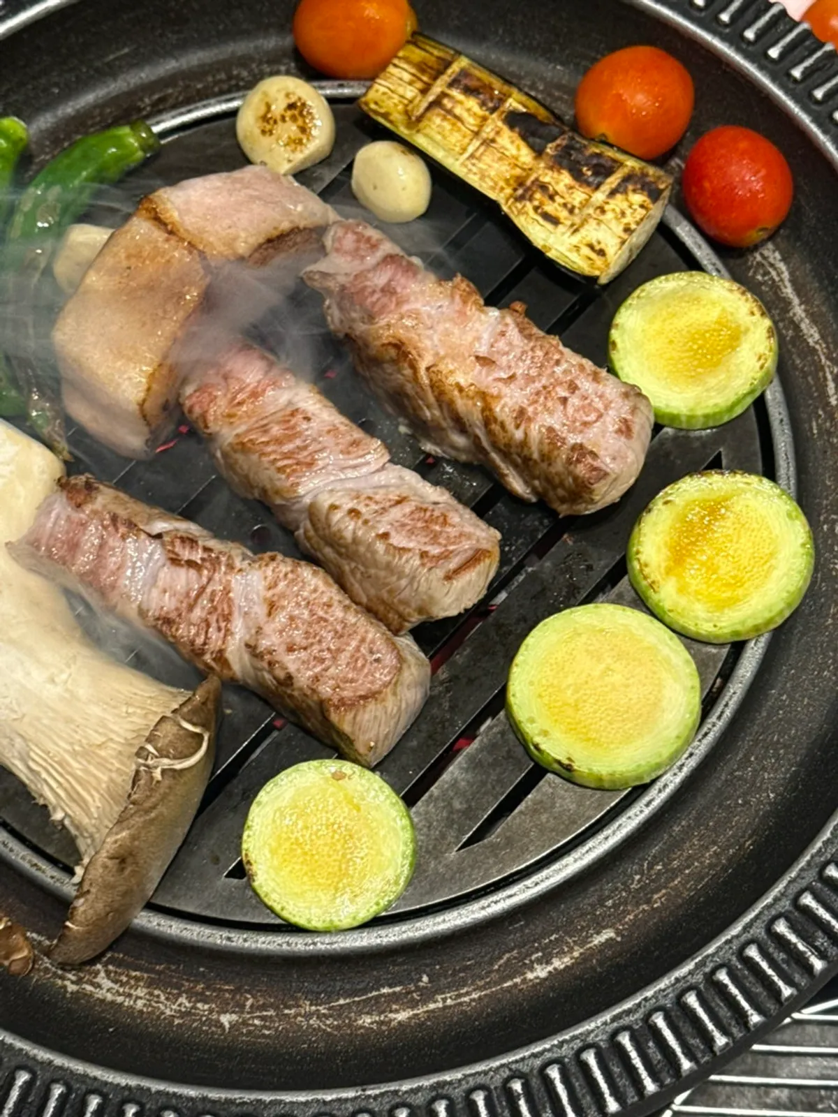 Staff member grilling the whole pig meat on the grill