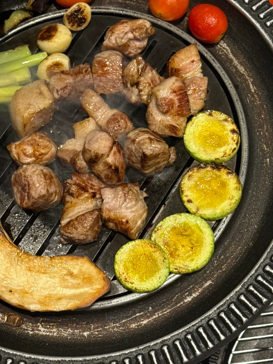 Grill with meat and vegetables cooking together